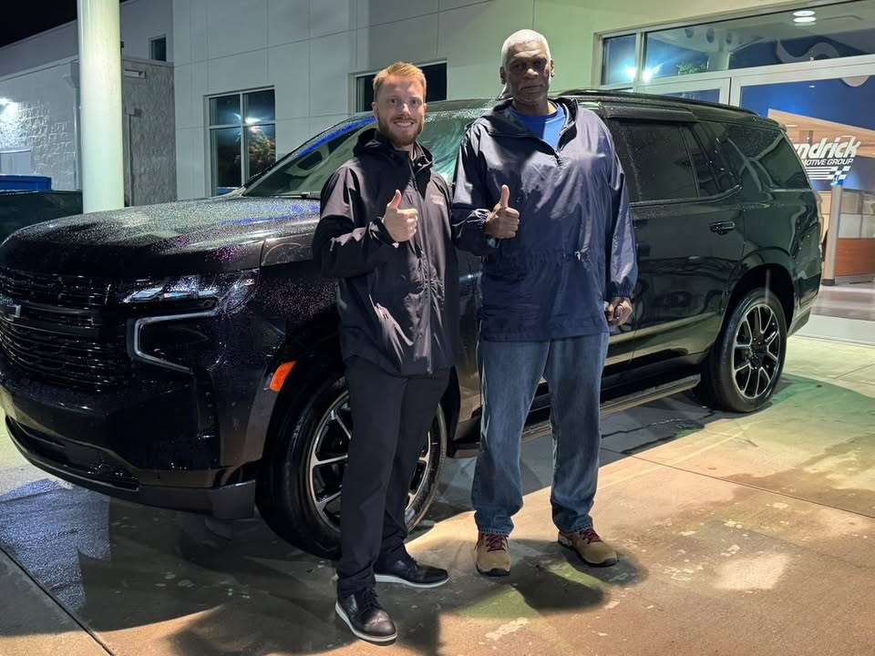 Luke Laliberte delivering a vehicle to a happy client