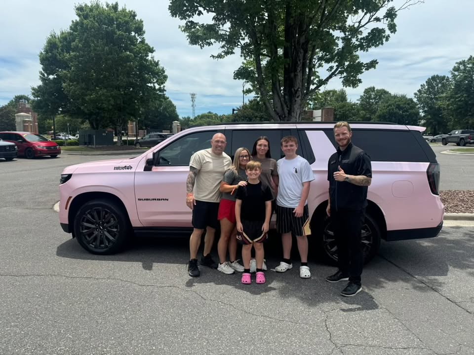 Luke Laliberte with a family and their new vehicle