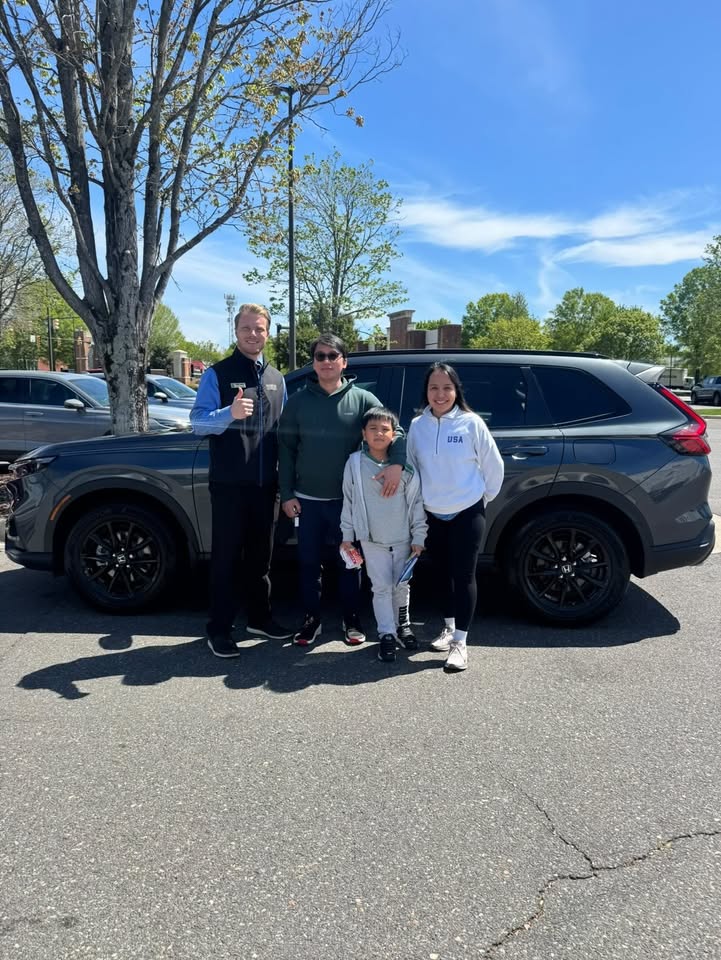 Luke Laliberte with a family and their new Honda SUV